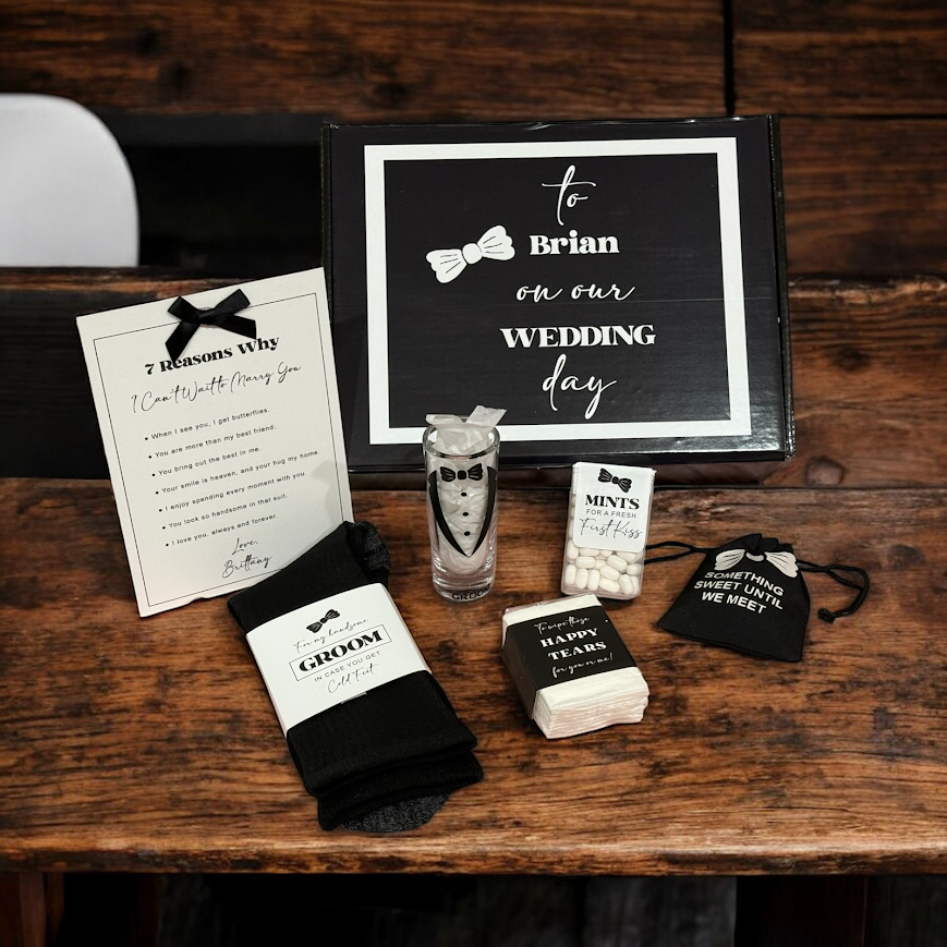 Wedding day-themed items including socks, a glass, and a sign on a wooden surface.