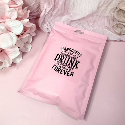 Pink poly pouch with humorous text on a pink background with flowers