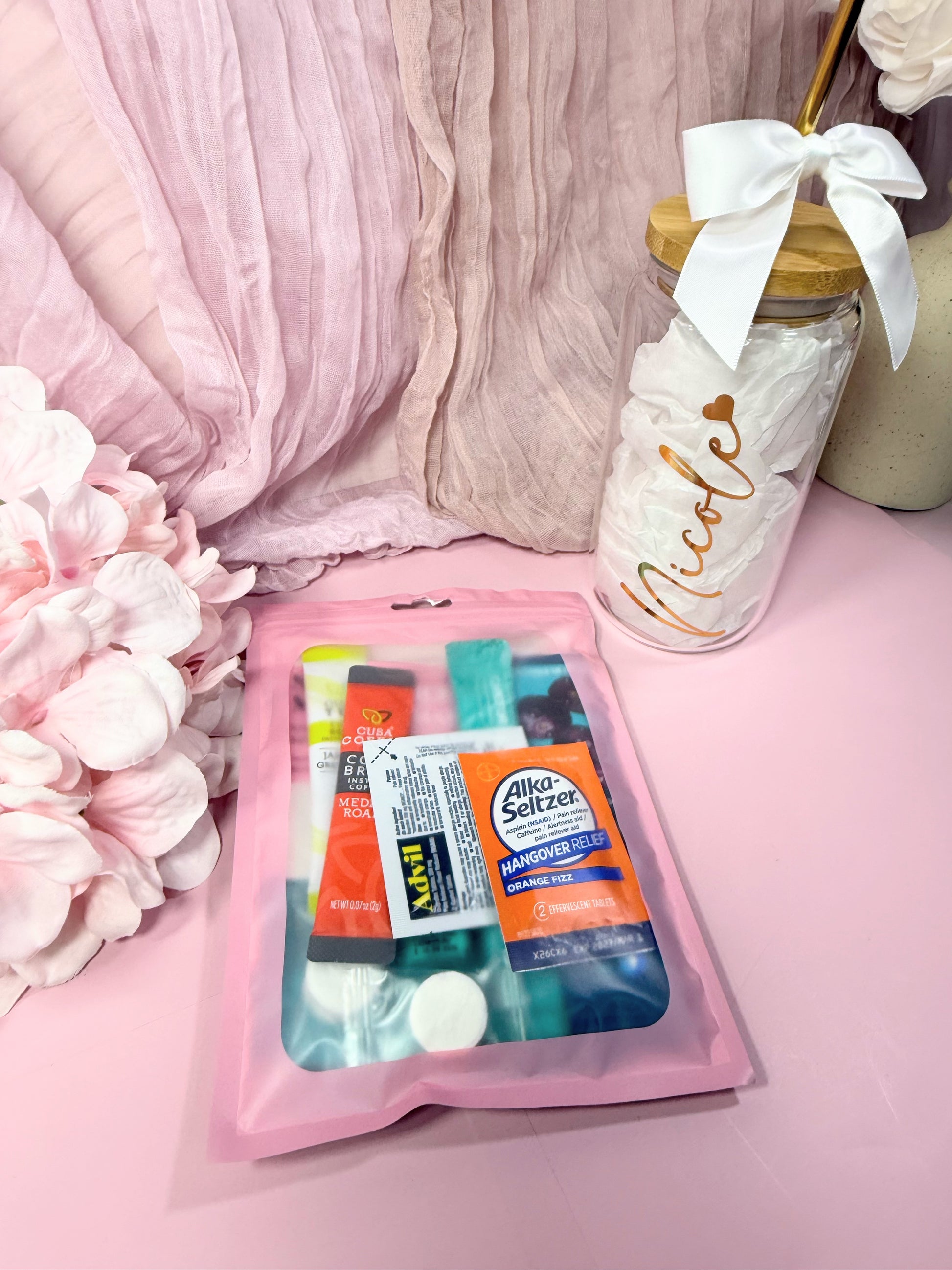 Pink Poly Pouch package showing what a packed Hangover Recovery Kit looks like packed with products (front side of package)