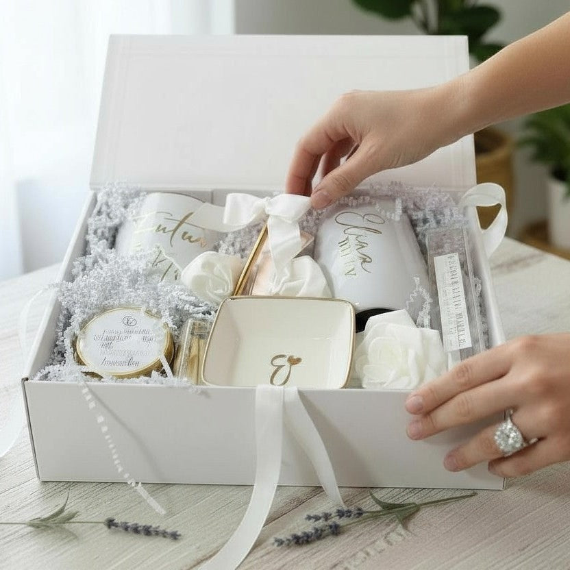 White gift box with decorative items on a light surface