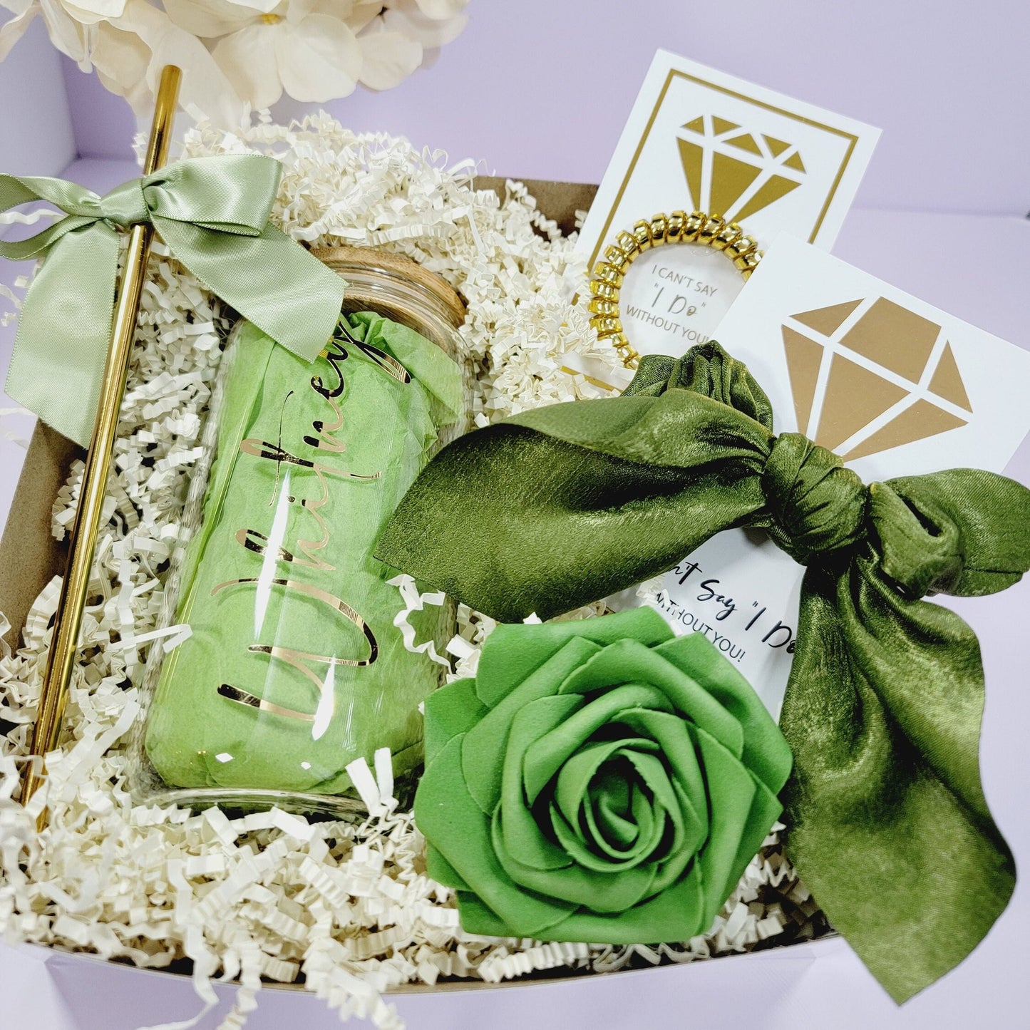 Includes a green and gold gift box filled with a green glass jar with a gold inscription, a green rose, a green satin ribbon, and two cards with gold diamond designs and the text "I can't say I Do without you!" and "at Say 'I Do' without you!"