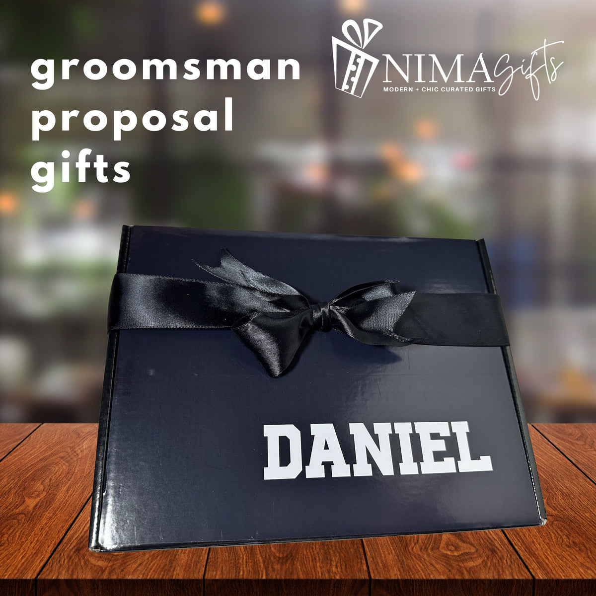 shown a sample groomsman proposal gift box with a black bow and personalized with the recipient name