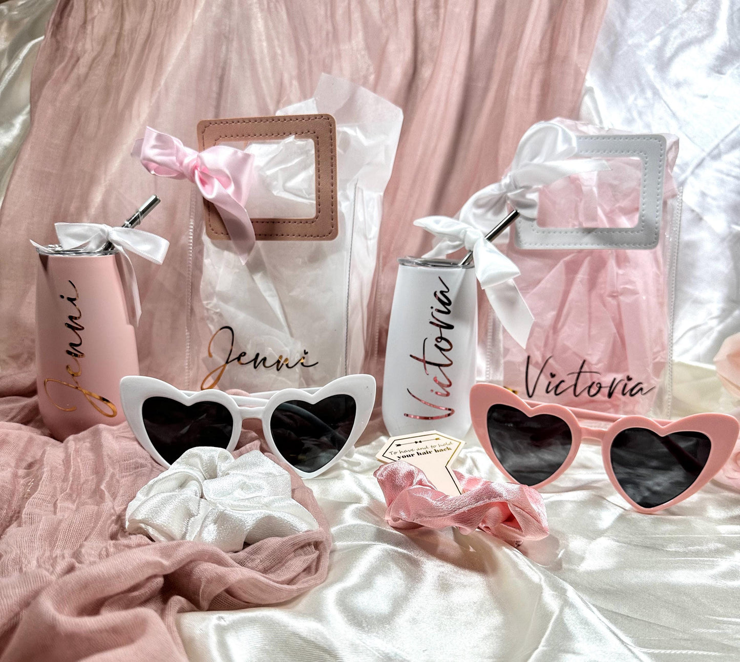 Personalized Clear Tote Bag with Leatherette handles in white and dusty rose color as well as bow, Bridesmaid Tumbler & Sunglasses with Champagne Flute Gift Set which is also personalized.