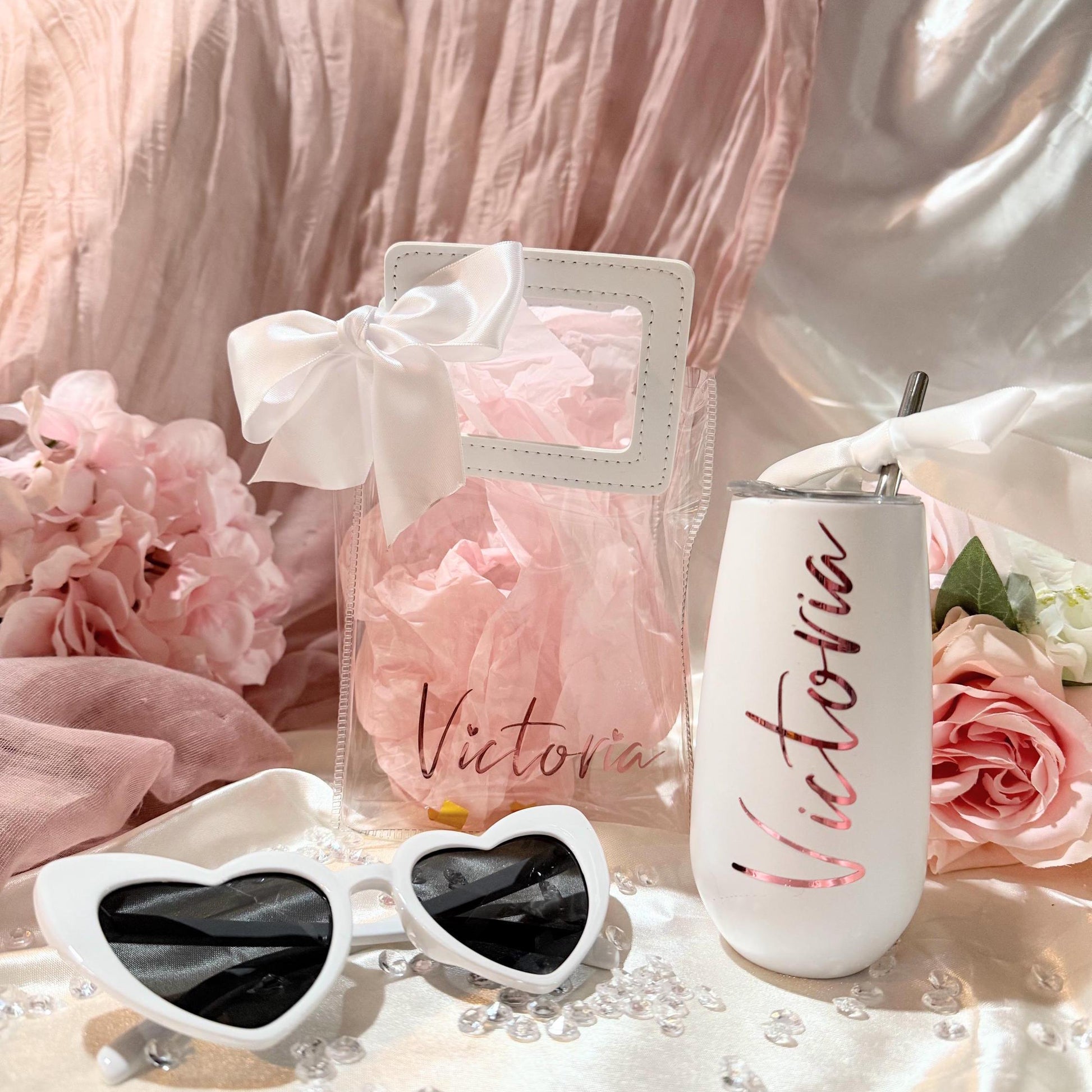 Personalized Clear Tote Bag Gift Set with Leatherette handles in white and a white bow. White heart shaped sunglasses and a white silk scrunchie (not shown)