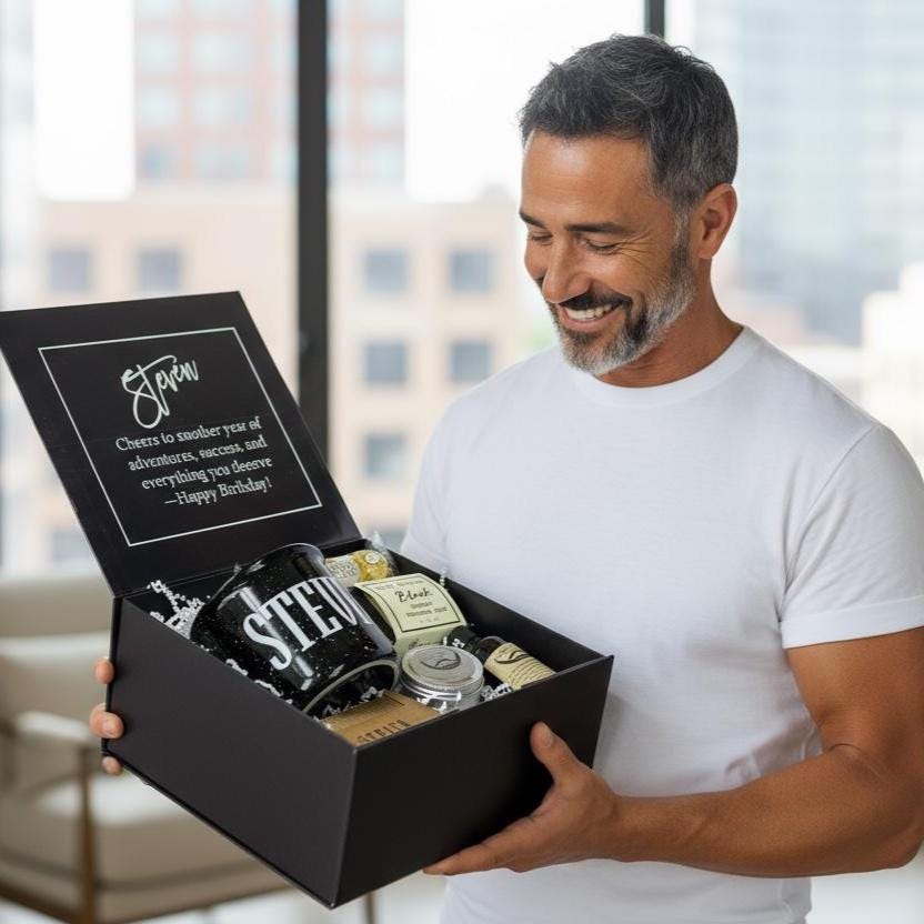 Smiling man holding a luxury personalized men’s birthday gift box with beard care set, chocolates, custom mug, engraved comb, and handmade soap. A stylish and modern men’s gift that feels premium and personal, designed for birthdays, Father’s Day, anniversaries, Christmas, or Valentine’s Day. Perfect for women shopping for boyfriends, husbands, or dads, this customizable gift box combines chic presentation with meaningful keepsakes he’ll actually use and love.