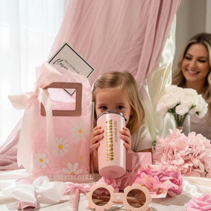 Flower Girl Proposal Gift Bag with PU leather handles, filled with personalized keepsakes like tumbler, scrunchie, sunglasses, and greeting card. A playful alternative to the flower girl proposal box, this personalized flower girl gift makes the perfect junior bridesmaid proposal gift, bridal party wedding gift, or kids wedding gift keepsake.