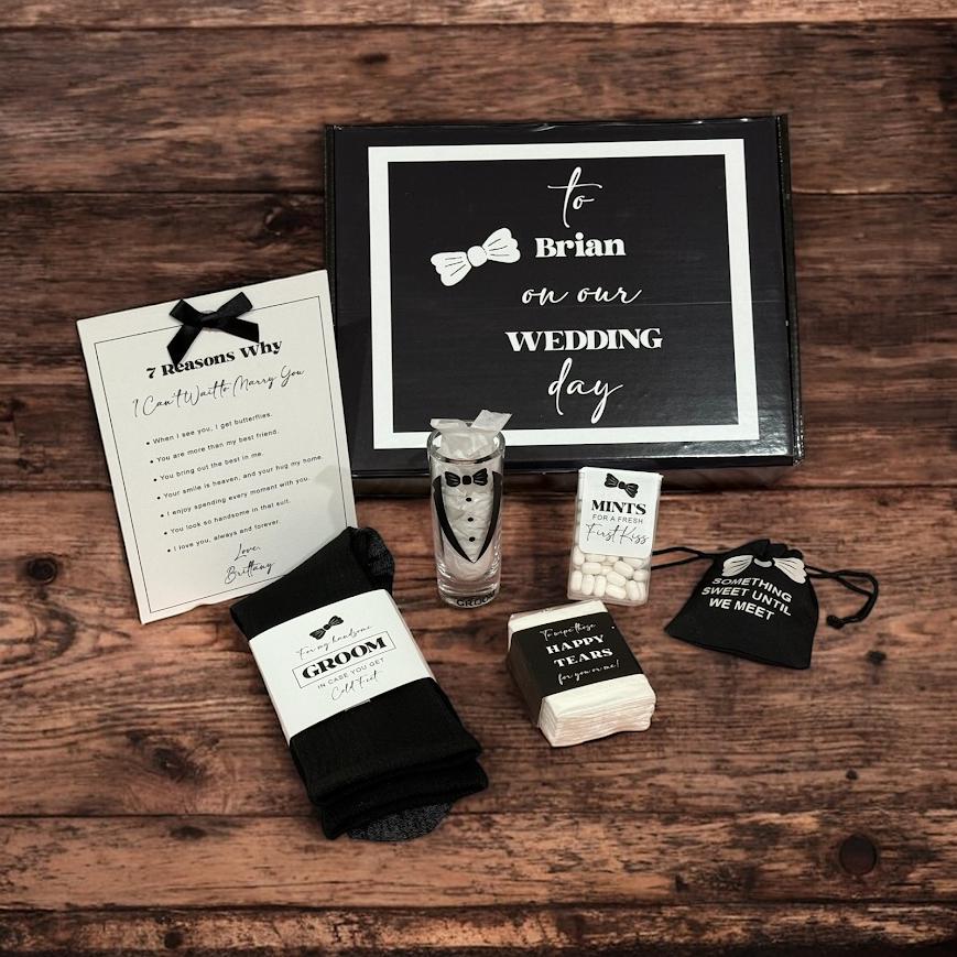 Wedding day gift set from bride to groom on their wedding day, styled on table with a personalized and custom box, printed message, socks, glass, mints, and keepsake items. Seven reasons I want to marry you today gift.