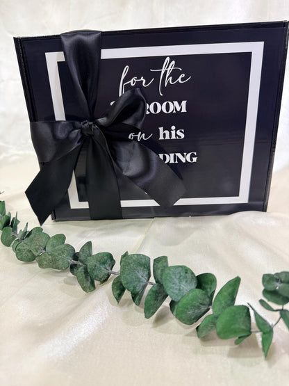 view of a final package for a best man to groom day of wedding gift box.