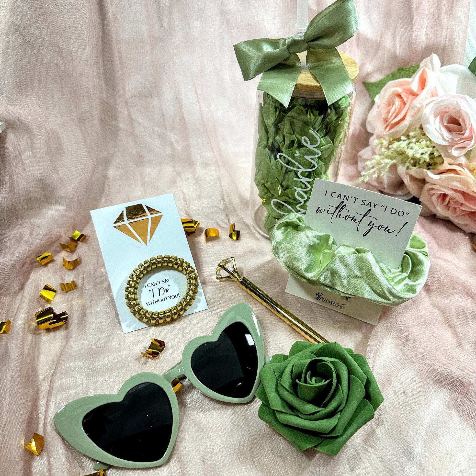 what's included in the bridesmaid gift box is a 16oz tumbler, a sage green hair scrunchie, sage heart shaped sunglasses, a gold diamond pen with a telephone scrunchie and a green foam rose. Packed in a gorgeous gift box ready to ship.