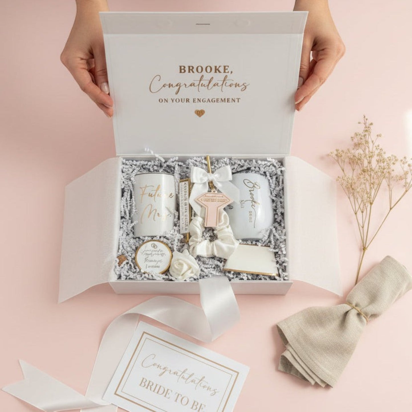 Engagement gift set with personalized card on a pink background