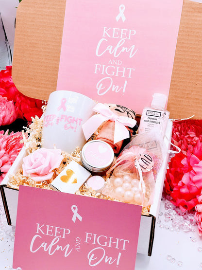 A cancer care gift box for women containing various items such as a white ceramic tea cup, bath crystals, soy candle, and lip balm, personalized with a name and a fighting message.
