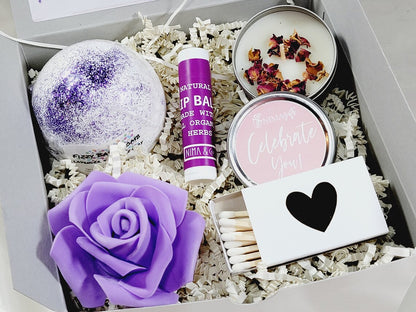 Purple self-care gift box with lavender spa items, ideal for women and best friends, including skincare and relaxation products.