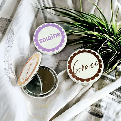 Pink and purple flower girl proposal gift compact mirror with gold accents, featuring floral design and NIMA Gifts branding.