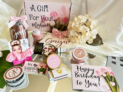 birthday gift basket for women – Beautiful birthday gift basket for women including a tumbler, soy candle, pen, and pink cotton scrunchie, arranged in a sturdy keepsake gift box.