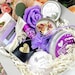 Purple self-care gift box with lavender spa items, perfect for women, featuring skincare products and a thoughtful care package.