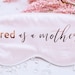 Personalized silky satin sleep mask with "Tired as A Mother" text, designed for comfortable sleep and gift-giving.