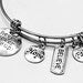 Silver friendship charm bracelet with inspirational heart and star charms, featuring adjustable chain and clasp.