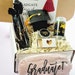 Personalized graduation gift box for women by NIMA Gifts, includes luxury items for college or high school grads, 2026 celebration.
