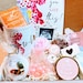 Pregnancy gift basket with postpartum care items, new mom and baby essentials in a decorative gift box for expecting mothers.